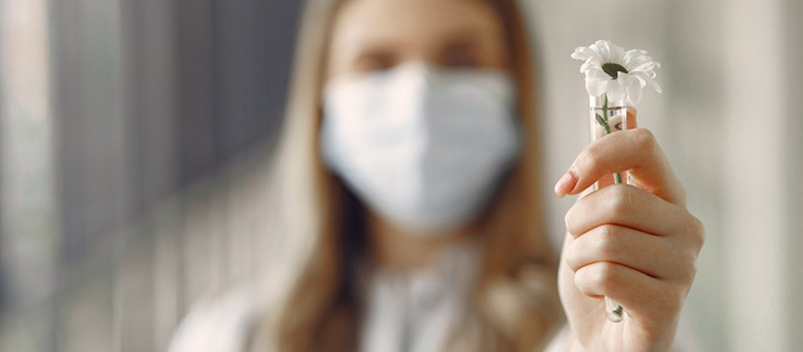 Medical student at the hall. Woman in a white uniform. Doctor in masks. Coronavirus theme.